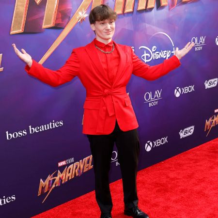 Matt Lintz wears a red suit for an event